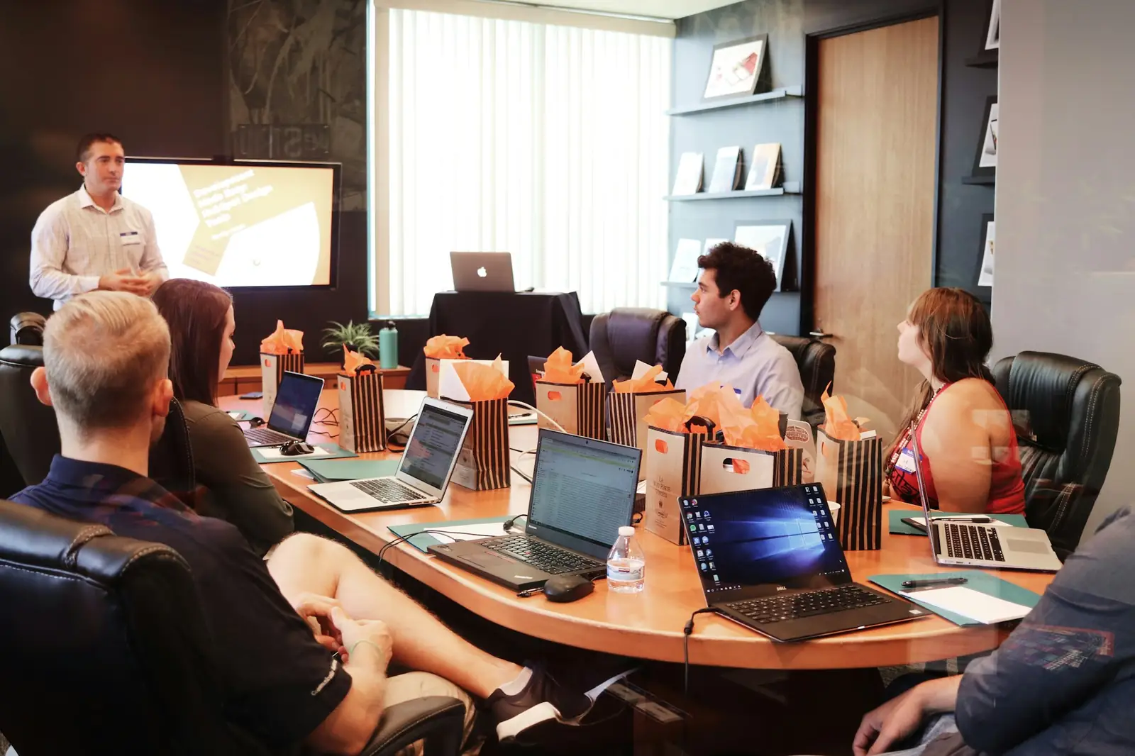 An adviser presenting figures to a business team